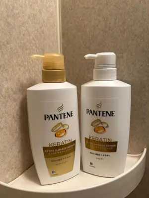 two bottles of paint thinner and keratin on a shelf at Kotori Itabashi in Tokyo