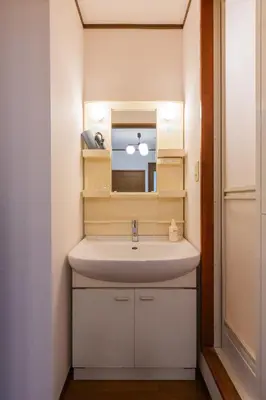 a bathroom with a sink and a mirror at Kotori Itabashi in Tokyo