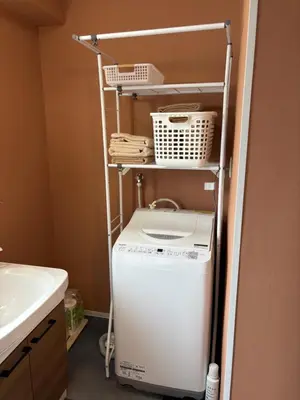 a washer and dryer in a bathroom next to a sink at Art House Katsushika in Tokyo