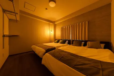 a hotel room with two beds in a room at Terrace Tokyo Otsuka in Tokyo