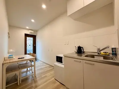 a kitchen with a sink and a counter top at Hanshe Hotel Sumida No 3, Skytree & Asakusa 天空树 浅草 in Tokyo