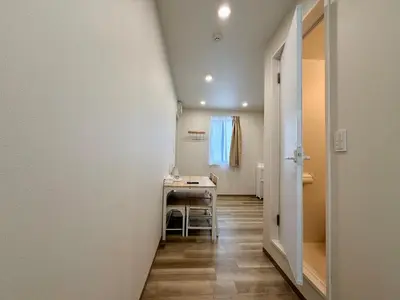 a hallway with a table and chairs in a room at Hanshe Hotel Sumida No 3, Skytree & Asakusa 天空树 浅草 in Tokyo
