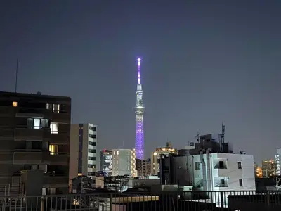 a city with a tower lit up in purple at Hanshe Hotel Sumida No 3, Skytree & Asakusa 天空树 浅草 in Tokyo