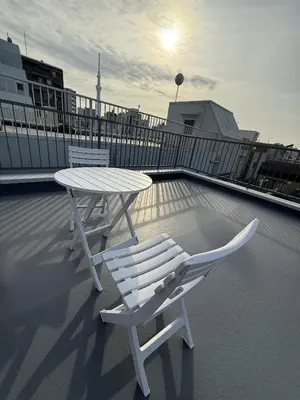 a white table and chairs on a roof at Hanshe Hotel Sumida No 3, Skytree & Asakusa 天空树 浅草 in Tokyo