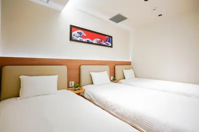two beds sitting next to each other in a room at Nakano World Hotel in Tokyo