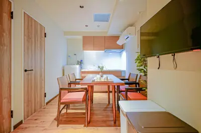 a kitchen and dining room with a table and chairs at Nakano World Hotel in Tokyo