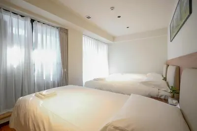 a hotel room with two beds and a window at Nakano World Hotel in Tokyo