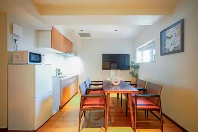 a kitchen and dining room with a table and chairs at Nakano World Hotel in Tokyo