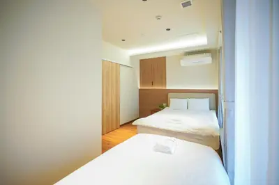 a small room with two beds in it at Nakano World Hotel in Tokyo