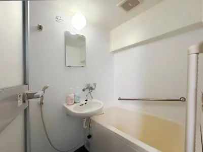 a white bathroom with a sink and a bath tub at shinjuku kasa 1302 in Tokyo