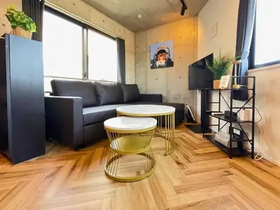 a living room with a couch and a table at GLANNIR Higashi kitazawa 402 in Tokyo