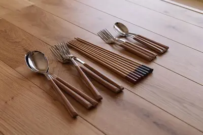 a group of forks and spoons on a wooden table at Home suite Home Hatsudai - 1 stop from Shinjuku! Your urban hideaway 3BR 6beds in Tokyo