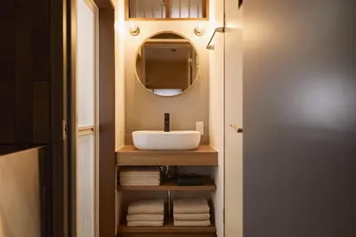 a bathroom with a sink and a mirror and towels at Home suite Home Hatsudai - 1 stop from Shinjuku! Your urban hideaway 3BR 6beds in Tokyo