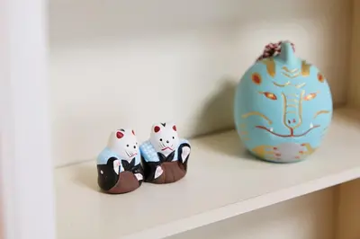 a shelf with three figurines of cats on it at Home suite Home Hatsudai - 1 stop from Shinjuku! Your urban hideaway 3BR 6beds in Tokyo