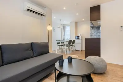 a living room with a couch and a table at Tokyo Modern Sakura House Gakugei 7min Shibuya by TRAIN Sakura River 10 min in Tokyo