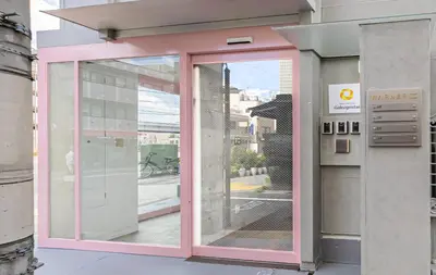 a pink door on the side of a building at Tokyo Modern Sakura House Gakugei 7min Shibuya by TRAIN Sakura River 10 min in Tokyo