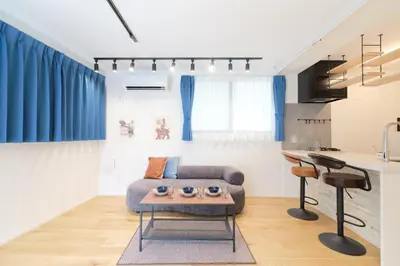 a living room with a couch and a table at monthly Grand Maison Natsumezaka in Tokyo