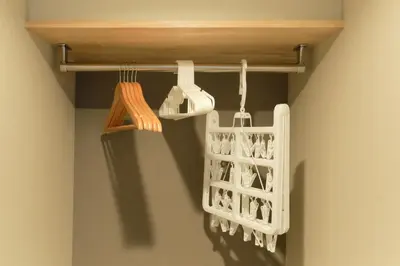 a closet with utensils hanging from a rack at monthly Grand Maison Natsumezaka in Tokyo