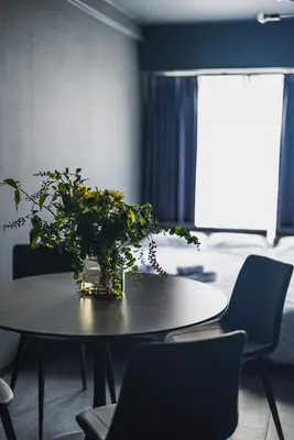 a table with a vase of flowers on top of it at SLL Urban Suites Shibuya in Tokyo