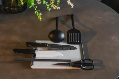 a table with a cutting board with utensils on it at SLL Urban Suites Shibuya in Tokyo