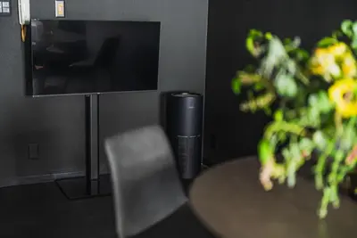 a room with a table and a tv and a chair at SLL Urban Suites Shibuya in Tokyo