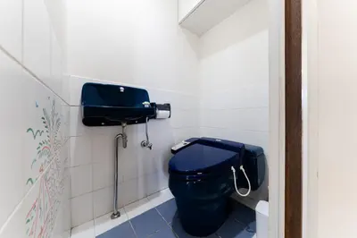 a bathroom with a blue toilet in a stall at Vacation Stay Sanesu in Tokyo