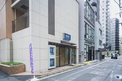 a building with a sign on the side of a street at SLL Urban Suites Akasaka in Tokyo