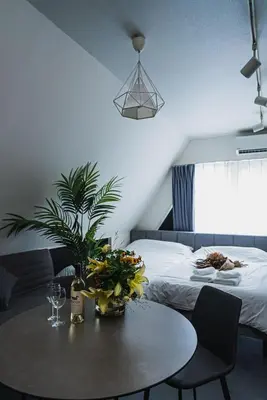 a living room with a table and a bed at SLL Urban Suites Akasaka in Tokyo