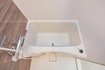 a white sink in the corner of a bathroom at Diamond Mansion Apartment Hotel in Tokyo