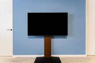 a television on a stand in front of a blue wall at Haneda Direct Bus 1h 2BR 2LDK Luxury Mattress in Tokyo