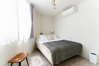a bedroom with a bed and a chair and a window at Haneda Direct Bus 1h 2BR 2LDK Luxury Mattress in Tokyo