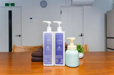 two bottles of cleaner sitting on a wooden table at Haneda Direct Bus 1h 2BR 2LDK Luxury Mattress in Tokyo