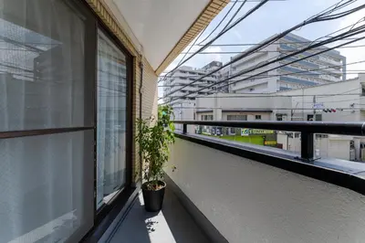 a potted plant sitting on a balcony with a window at Haneda Direct Bus 1h 2BR 2LDK Luxury Mattress in Tokyo