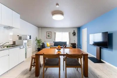 a kitchen and living room with a table and chairs at Haneda Direct Bus 1h 2BR 2LDK Luxury Mattress in Tokyo