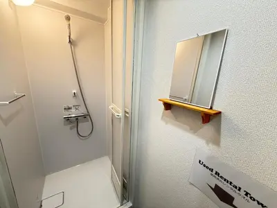 a bathroom with a shower and a mirror at Wabi Sabi Hostel Shinjuku West in Tokyo