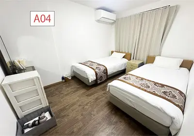 a hotel room with two beds and a shelf at Tabata Flower Village - Vacation STAY 45904v in Tokyo