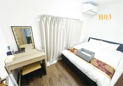 a bedroom with a bed and a desk with a mirror at Tabata Flower Village - Vacation STAY 45929v in Tokyo