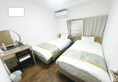 a hotel room with two beds and a mirror at Tabata Flower Village - Vacation STAY 45945v in Tokyo