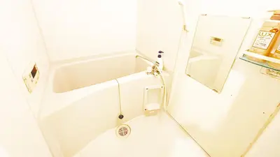 a small bathroom with a tub and a mirror at Ars Building 303 - Vacation STAY 46091v in Tokyo