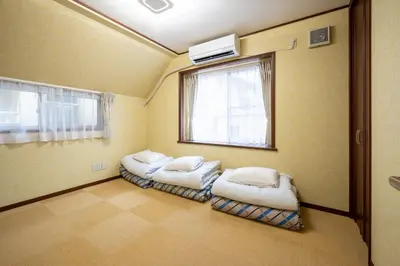 two beds in a room with a window at FAMILIA KAMTA 1 - Vacation STAY 20525 in Tokyo