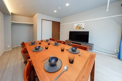 a conference room with a long wooden table and a flat screen tv at AI Grandir Azumabashi 1F - Vacation STAY 73753v in Tokyo