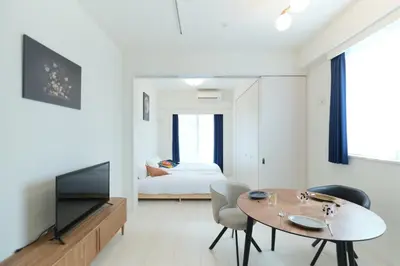a living room with a table and a bedroom at Cure Skytree - Vacation STAY 74017v in Tokyo