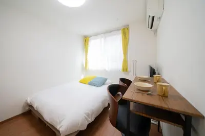 a bedroom with a bed and a desk with a table at Zenith Garden TOGOSHI - Vacation STAY 74206v in Tokyo