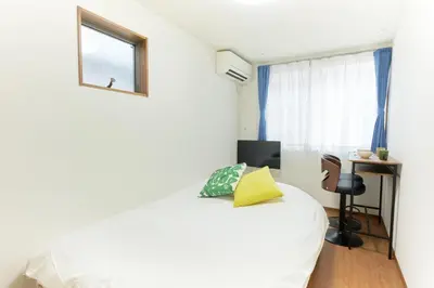 a bedroom with a white bed and a window at Zenith Garden TOGOSHI - Vacation STAY 74224v in Tokyo