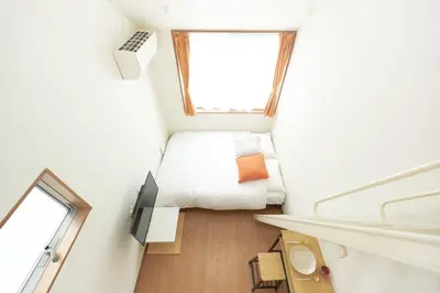 a small bedroom with a bed and a window at Zenith Garden TOGOSHI - Vacation STAY 74228v in Tokyo
