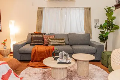 a living room with a couch and a table at Mi-APT Kitashinjuku in Tokyo
