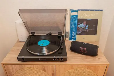 a cd player and a clock on top of a table at Mi-APT Kitashinjuku in Tokyo