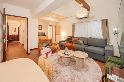 a living room with a couch and a table at Mi-APT Kitashinjuku in Tokyo