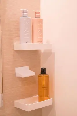 two bottles ofodorizers sit on shelves in a bathroom at HoshiyoriTokyo in Tokyo