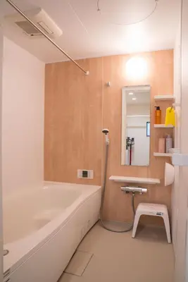 a bathroom with a bath tub and a sink at HoshiyoriTokyo in Tokyo